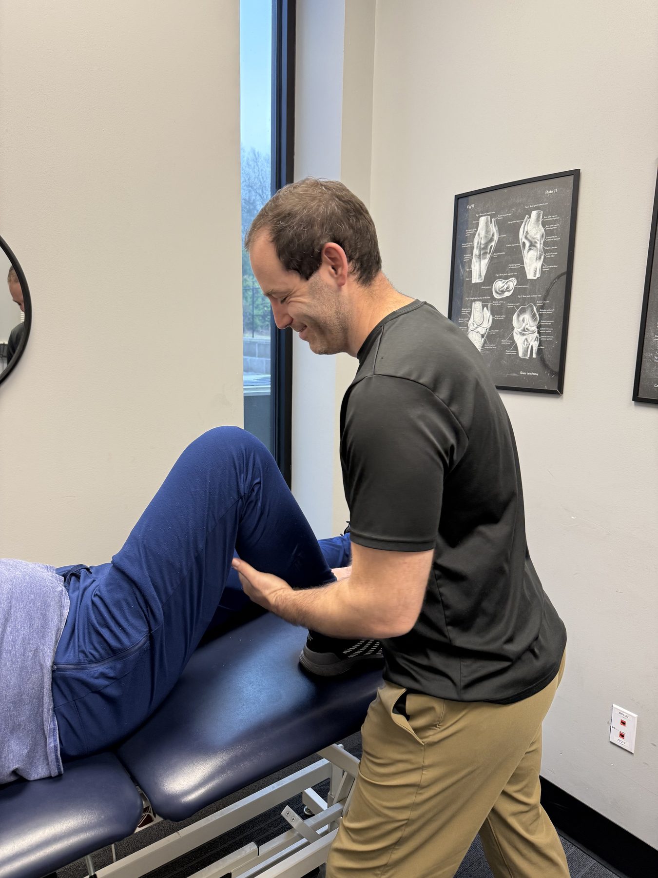 Doctor of physical therapy performing a lumbar assessment on a patient at Physio+ Lindale
